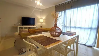 a living room with a table with a vase on it at Apartamento en Miño in A Coruña