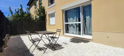 two chairs and a table in front of a window at Apartamento en Miño in A Coruña