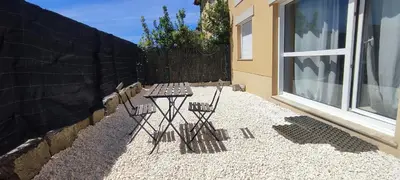 two chairs sitting on a patio next to a window at Apartamento en Miño in A Coruña