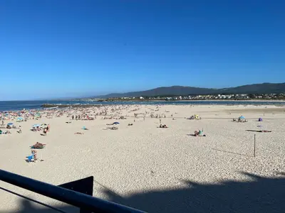 a beach with a lot of people on it at Apartamento vacacional foz in Foz