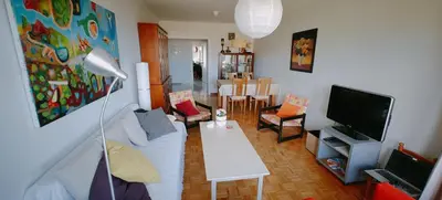 a living room with a white couch and a tv at Piso luminoso y acogedor en primera línea de playa Covas Viveiro in Vivero