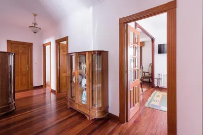 a room with two glass doors and a wooden floor at Luminoso apartamento reformado en villa termal in Cuntis