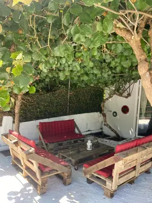 two chairs and a table under a tree at Casita rústica in Cambre
