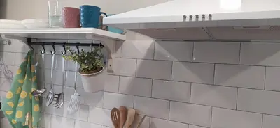 a kitchen with white tiles on the wall at Casiña d'afreita in Rinlo