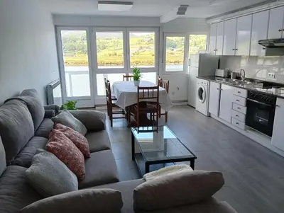 a living room with a couch and a table at Apartamento Ría Navia in Navia