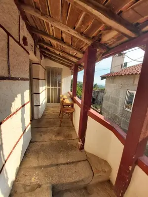 an empty porch of a house with a wooden roof at Casa das Peleteiro Ribeira Sacra in Ourense