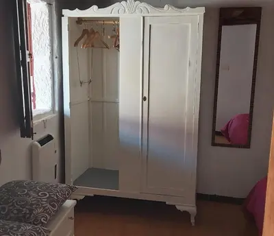 a white cabinet with a mirror in a room at Casa das Peleteiro Ribeira Sacra in Ourense