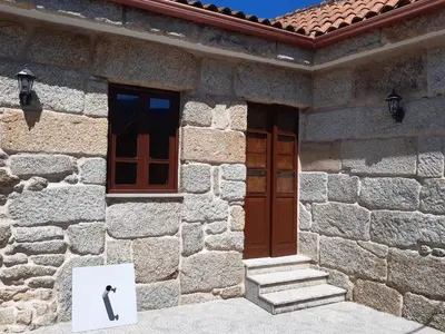 a building with a door and a picture of a man on it at Casa Rural dos Chaos in Arnoia