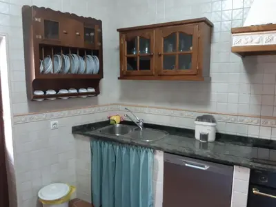 a kitchen with a sink and a microwave at Casa Rural dos Chaos in Arnoia