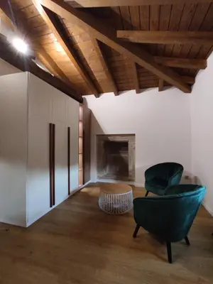 a living room with a couch and a chair and a fireplace at Casa Lagarto, (Ribeira Sacra), Taboada in Taboada