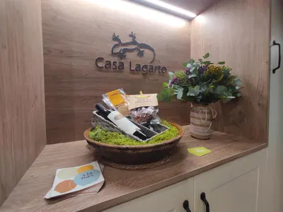 a counter with a bowl of moss and a sign on a wall at Casa Lagarto, (Ribeira Sacra), Taboada in Taboada