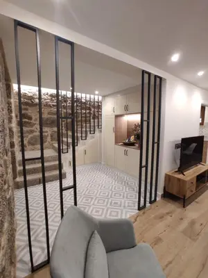 a living room with a couch and a television at Casa Lagarto, (Ribeira Sacra), Taboada in Taboada