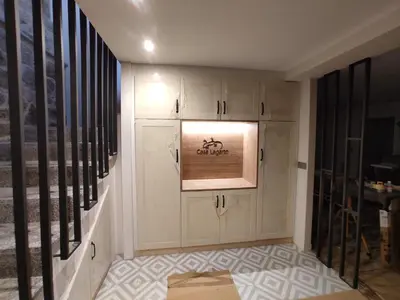 a hallway with white cabinets and a painting on the wall at Casa Lagarto, (Ribeira Sacra), Taboada in Taboada