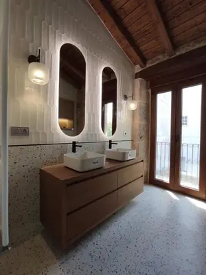 a bathroom with two sinks and two mirrors at Casa Lagarto, (Ribeira Sacra), Taboada in Taboada