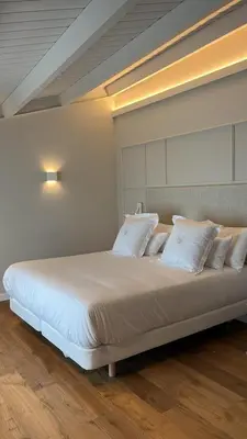 a large bed with white pillows in a room at De la Osa Hotel in Abres