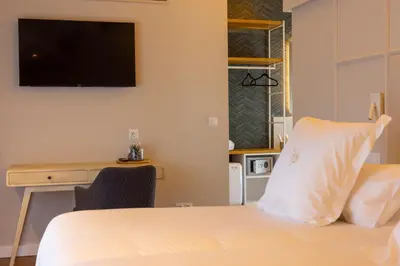 a hotel room with a bed and a tv on the wall at De la Osa Hotel in Abres
