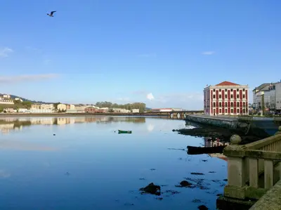 a large body of water with a bird flying over it at The Cliffs - Mansión del Indiano I in Viveiro
