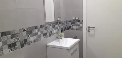 a white bathroom with a sink and a mirror at LOFT FRIOL in Friol
