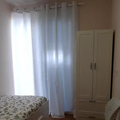 a bedroom with a bed and a white curtain at LOFT FRIOL in Friol