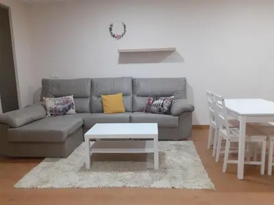 a living room with a couch and a table at LOFT FRIOL in Friol