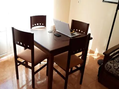 a dining room table with a laptop computer on it at En primera linea de la playa Rapadoira in Foz
