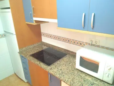 a kitchen with a counter top with a microwave at En primera linea de la playa Rapadoira in Foz