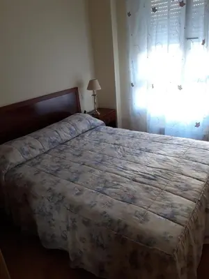 a bedroom with a bed and a window at En primera linea de la playa Rapadoira in Foz