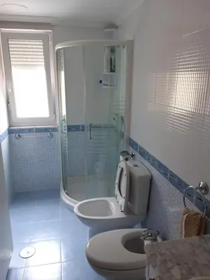 a bathroom with a shower and a toilet and a sink at En primera linea de la playa Rapadoira in Foz