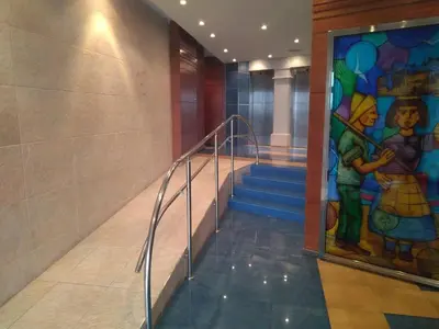 a hallway with a staircase with a painting on the wall at En primera linea de la playa Rapadoira in Foz