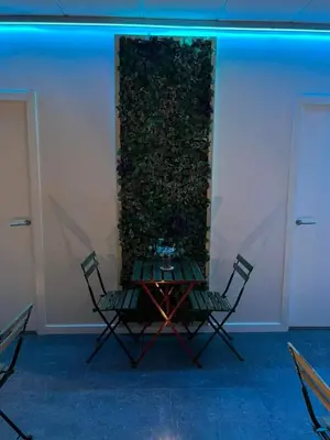 a group of white chairs and tables in a room at Albergue As Pozas Termais in Caldas de Reis