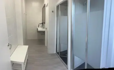 a bathroom with a glass shower and a sink at Albergue As Pozas Termais in Caldas de Reis