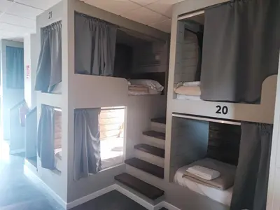 a room with bunk beds and stairs in it at Albergue As Pozas Termais in Caldas de Reis