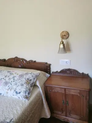 a bedroom with a wooden bed with a wooden dresser at La casona El Espín in Serandinas