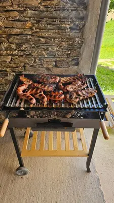 a grill with meat and other food on it at La casona El Espín in Serandinas
