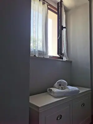 a window with a stuffed animal sitting on top of a dresser at La casona El Espín in Serandinas