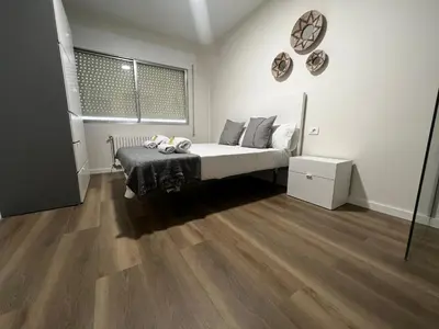 a bedroom with a bed and a wooden floor at Oktheway Ultreia in Sarria