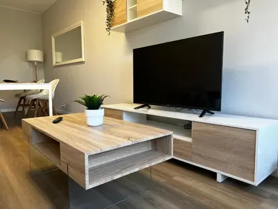 a living room with a flat screen tv on a entertainment center at Oktheway Ultreia in Sarria