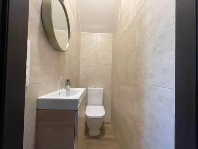 a bathroom with a sink and a toilet and a mirror at Casa Os Chocolateiros in Ourense