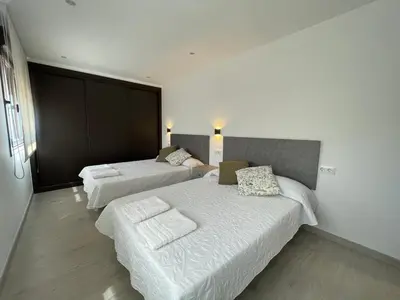 a hotel room with two beds and a couch at Casa Os Chocolateiros in Ourense