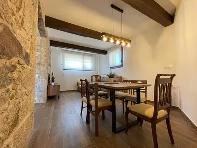 a dining room with a table and chairs at Casa Os Chocolateiros in Ourense