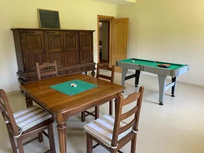 a dining room with a table and a pool table at As Pias in Pontevedra