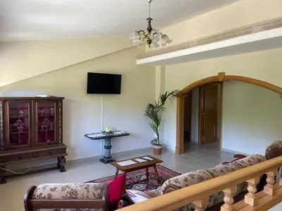 a living room with a couch and a tv at As Pias in Pontevedra