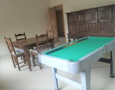 a room with a pool table and a table and chairs at As Pias in Pontevedra