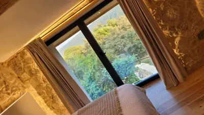 a room with a large window in a room at Casa Leirón in Parada del Sil
