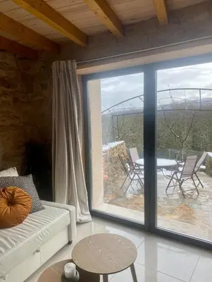 a living room with a large sliding glass door at Casa Leirón in Parada del Sil