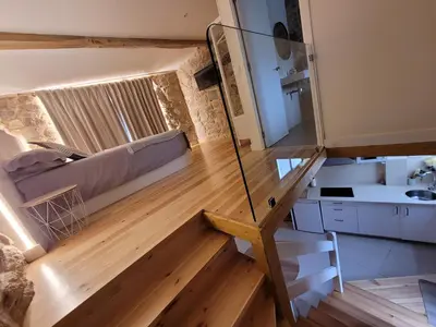 a room with a staircase and a room with a bed at Casa Leirón in Parada del Sil