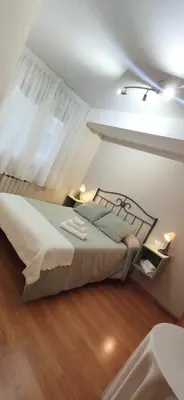 a bedroom with a large bed with a window at La morada del Museo in Ponferrada