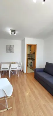 a living room with a couch and a table and chairs at La morada del Museo in Ponferrada