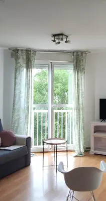 a living room with a couch and a table in front of a window at La morada del Museo in Ponferrada