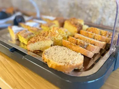 a tray filled with bread and biscuits on a table at ACOUGA Hotel Boutique in Celanova